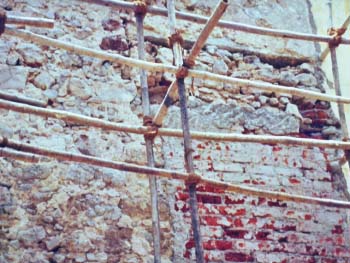 The walls of the church were originally made of stone and lime-mortar. The photograph alongside shows the underlying wall construction in the area where the old choir door entrance once was. This was bricked up in 1966. The old stone and mortar construction to the left is clearly visible.